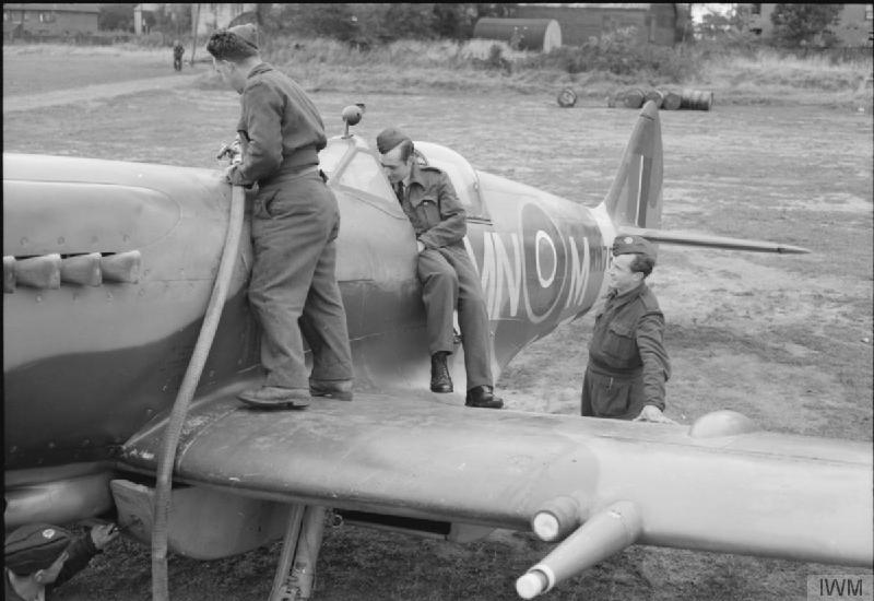 Photo of ground crew fueling and readying a Spitfire